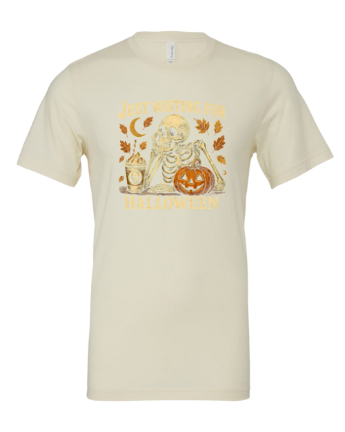 Beige t-shirt with skeleton and pumpkin graphic on a white background